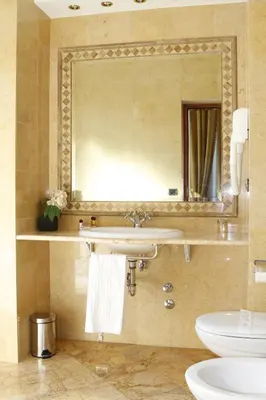 a bathroom with a sink and a mirror and a toilet at Hotel Villa Pinciana in Rome