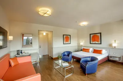 a hotel room with a bed and a couch at Grand Hotel Fleming by OMNIA hotels in Rome
