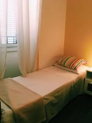 a small bedroom with a bed and a window at 4 You City Center Apartament in Rome