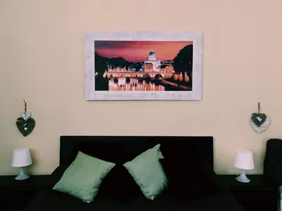 a living room with a couch and a picture on the wall at 4 You City Center Apartament in Rome