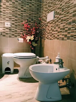 a bathroom with a toilet and a sink at 4 You City Center Apartament in Rome