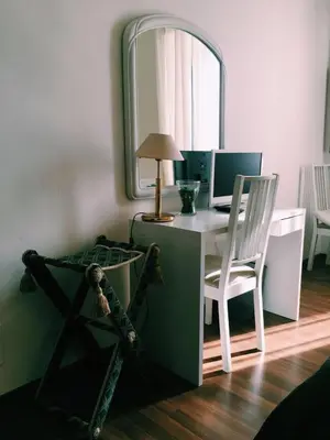 a room with a desk with a computer and a mirror at 4 You City Center Apartament in Rome