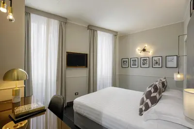a hotel room with a bed and a television at Stay Inn Rome Via Del Corso in Rome