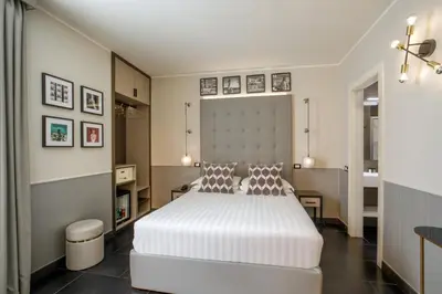 a bedroom with a large white bed in a room at Stay Inn Rome Via Del Corso in Rome
