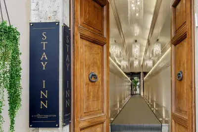 a hallway in a building with a door at Stay Inn Rome Via Del Corso in Rome