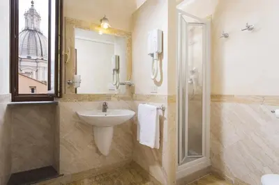 a bathroom with a sink and a shower at Hotel Teatro Pace in Rome