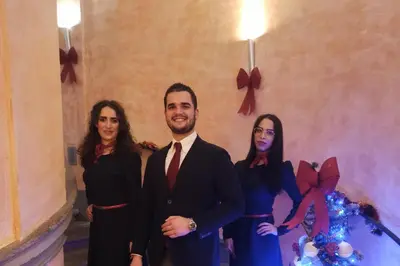 a man in a suit and two women in front of a wall at Hotel Teatro Pace in Rome