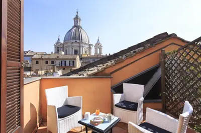 a patio with chairs and a table on a balcony at Hotel Teatro Pace in Rome