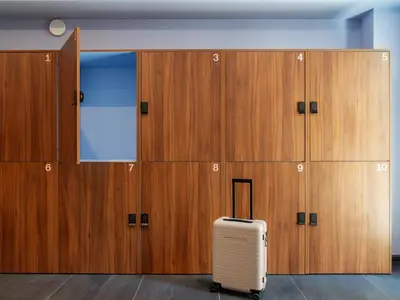a suitcase sits in front of a row of lockers at Numa Rome Vici in Rome