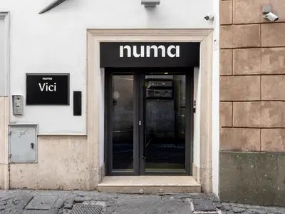 a entrance to a nummi store on the side of a building at Numa Rome Vici in Rome