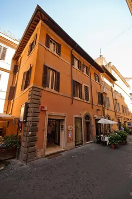 an orange building with a table in front of it at Trevi 41 Hotel in Rome