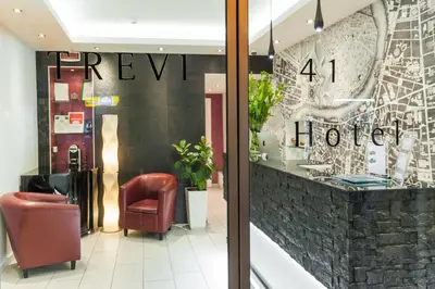a lobby of a hotel with a chair and a window at Trevi 41 Hotel in Rome