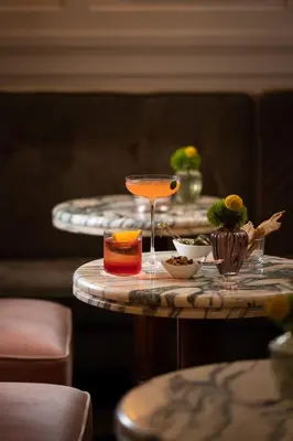 a table with a drink on top of it at Palazzo Ripetta in Rome