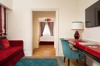 a room with a red desk and a red couch at Palazzo Ripetta in Rome