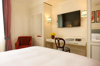 a hotel room with a bed and a desk and a tv at Palazzo Ripetta in Rome