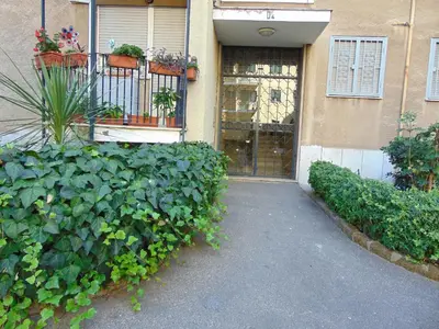 a building with a gate and plants in front of it at Studiohouserome in Rome