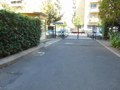 an empty street with a gate in front of a building at Studiohouserome in Rome