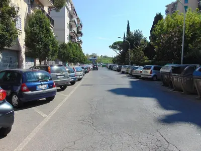 a street with cars parked on the side of the road at Studiohouserome in Rome