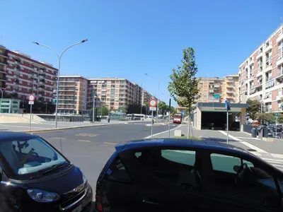 two cars parked on a city street with buildings at Studiohouserome in Rome