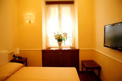a hallway in a building with two lights on the wall at Luxury Ludovisi Rooms in Rome