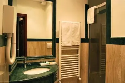 a bedroom with a bed and a desk and a bed sidx sidx sidx at Luxury Ludovisi Rooms in Rome