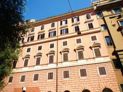 a large brick building with a lot of windows at Luxury Ludovisi Rooms in Rome
