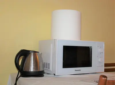 a microwave sitting on top of a table with a kettle at Hotel Eurorooms in Rome