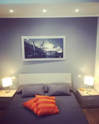 a bedroom with a bed with a picture on the wall at Caracalla Room Rental in Rome