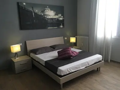 a bedroom with a bed with two lamps on it at Caracalla Room Rental in Rome