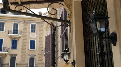 a building with a light on the side of it at Roma Room Hotel in Rome
