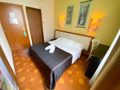 a hotel room with a bed with a towel on it at Roma Room Hotel in Rome