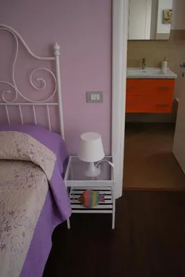 a bedroom with a bed with a lamp and a sink at Casanova in Rome