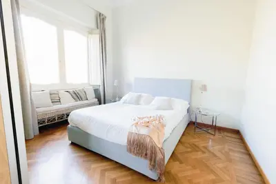 a bedroom with a large bed with a wooden headboard at Fontana Più Stella in Rome