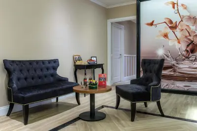 a room with two chairs and a table and a mirror at The Boutique Hotel in Rome