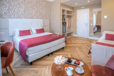 a bedroom with a bed and a living room at The Boutique Hotel in Rome