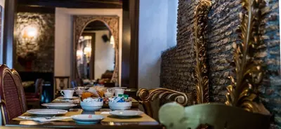 a table with plates and bowls on it with a mirror at Hotel Antica Locanda in Rome