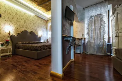 a bedroom with a bed and a tv on a wall at Hotel Antica Locanda in Rome