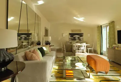 a living room with a couch and a table at Rocco Forte Hotel De Russie in Rome