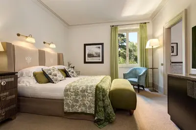 a hotel room with a bed and a window at Rocco Forte Hotel De Russie in Rome