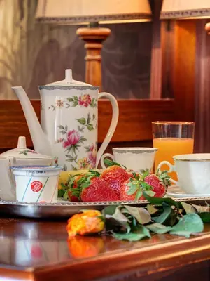 a table with a plate of food and a tea pot at Hotel Residenza In Farnese in Rome