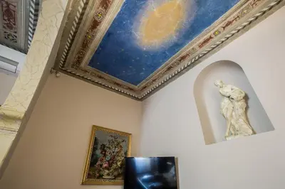 a room with a painting and a statue on the wall at Hotel Residenza In Farnese in Rome