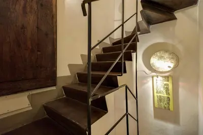 a spiral staircase in a house with aendant light at Residenza Torre Colonna in Rome
