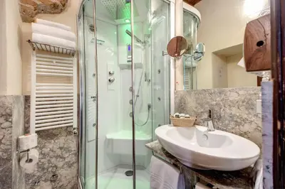 a bathroom with a sink and a shower at Residenza Torre Colonna in Rome