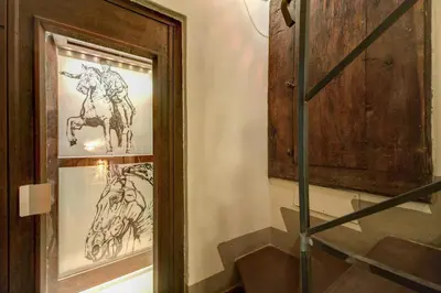 a framed picture of a horse on a wall at Residenza Torre Colonna in Rome