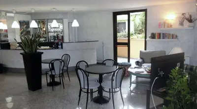 a room with a table and chairs and a counter at Hotel Desiderio in Rome