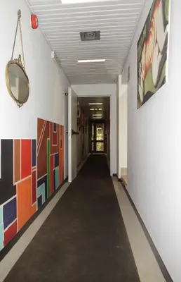 a hallway with a long corridor with art on the walls at Hotel Desiderio in Rome