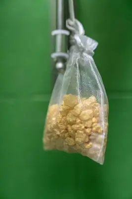 a plastic bag full of nuts hanging from a hook at Merulana Star in Rome
