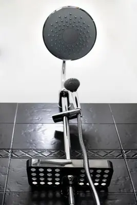 a shower head sitting on the floor in a bathroom at Merulana Star in Rome