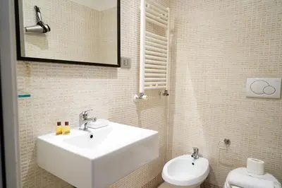 a pile of toilet paper and a roll of paper at Target Inn Rooms in Rome