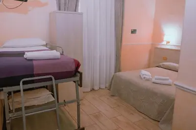 a small room with two beds and a small bedskirts at Hotel Aristotele in Rome
